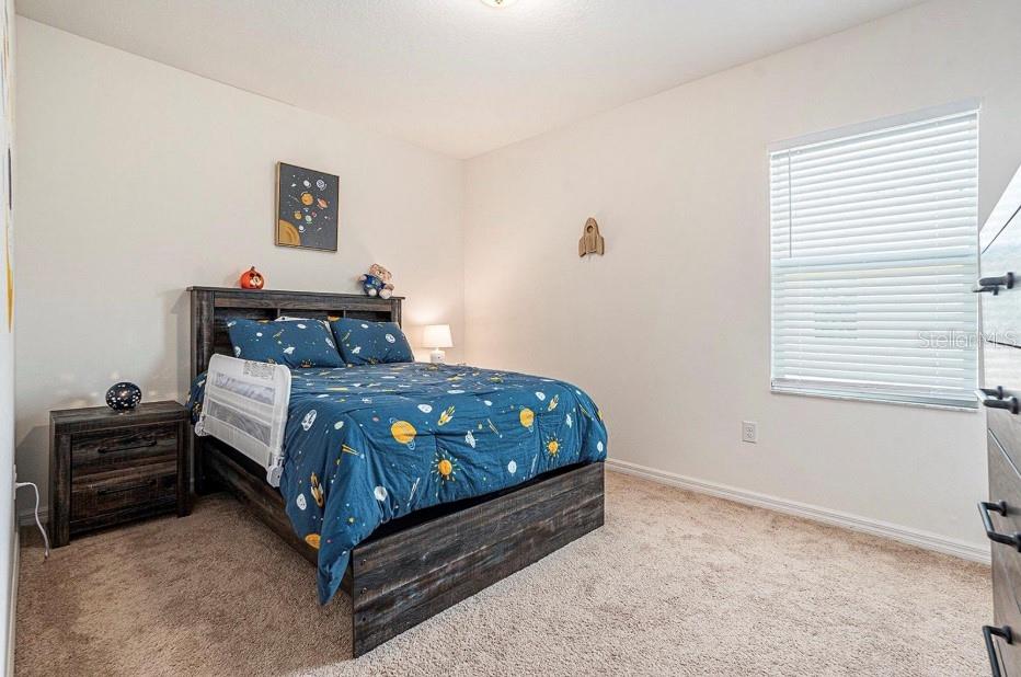 5521 Yellowfin Court New Port Richey, FL 34652 - Photo 12 of 23 a bedroom with a bed and a window