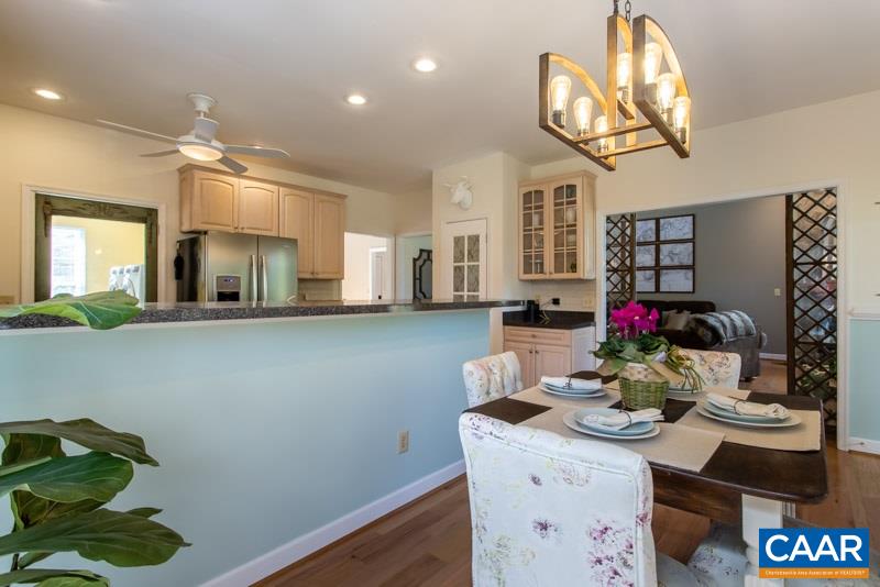 2637 Bybees Church Road Palmyra, VA 22963 - Photo 12 of 50 a kitchen with a sink dishwasher and a dining table with wooden floor