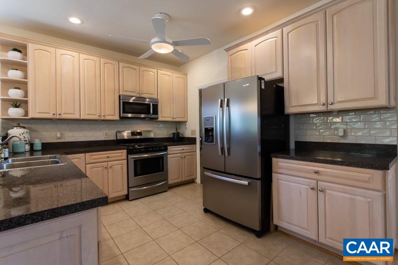 2637 Bybees Church Road Palmyra, VA 22963 - Photo 13 of 50 a kitchen with granite countertop a refrigerator a sink and white cabinets