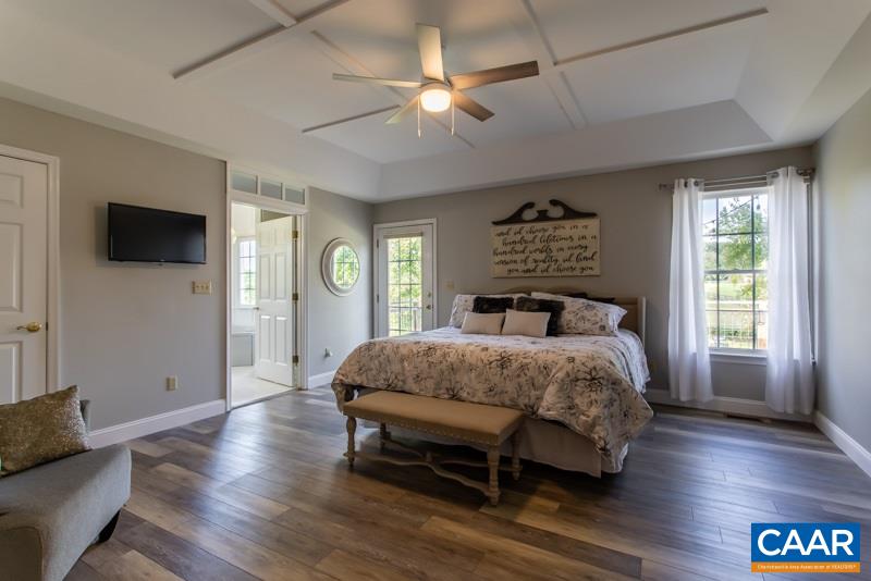 2637 Bybees Church Road Palmyra, VA 22963 - Photo 22 of 50 a bedroom with a bed and a flat screen tv