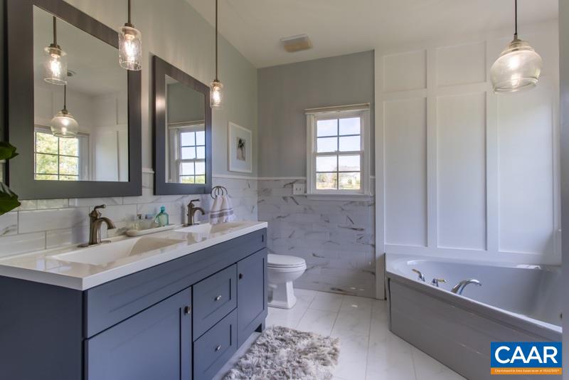 2637 Bybees Church Road Palmyra, VA 22963 - Photo 24 of 50 a bathroom with a double vanity sink a toilet and a mirror