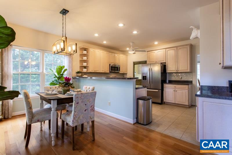 2637 Bybees Church Road Palmyra, VA 22963 - Photo 3 of 50 a kitchen with stainless steel appliances kitchen island granite countertop a refrigerator a stove a microwave oven a dining table and chairs with wooden floor