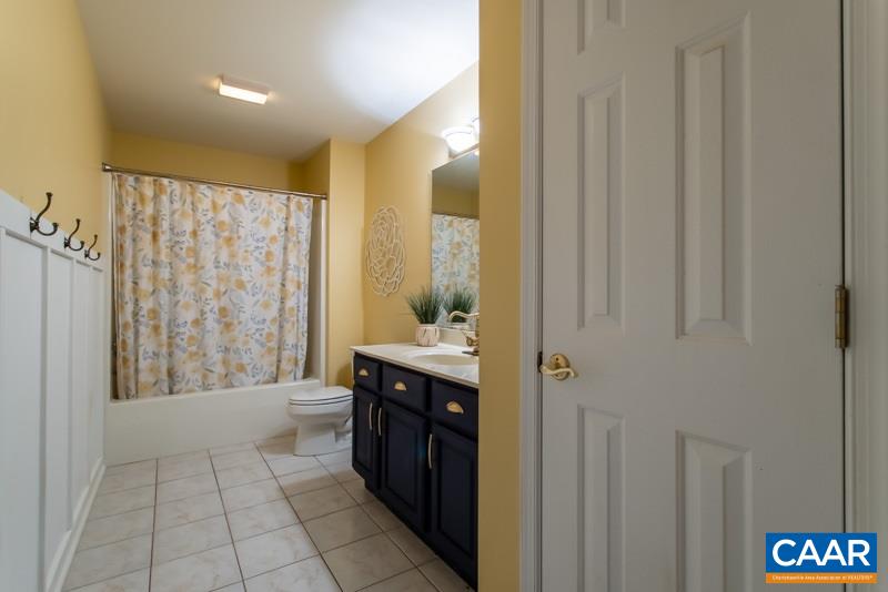 2637 Bybees Church Road Palmyra, VA 22963 - Photo 36 of 50 a bathroom with a granite countertop sink a mirror and a bathtub