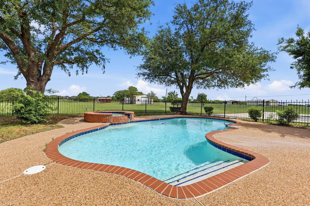 211 Bayne Road Haslet, TX 76052 - Photo 2 of 29 a view of a swimming pool with a yard