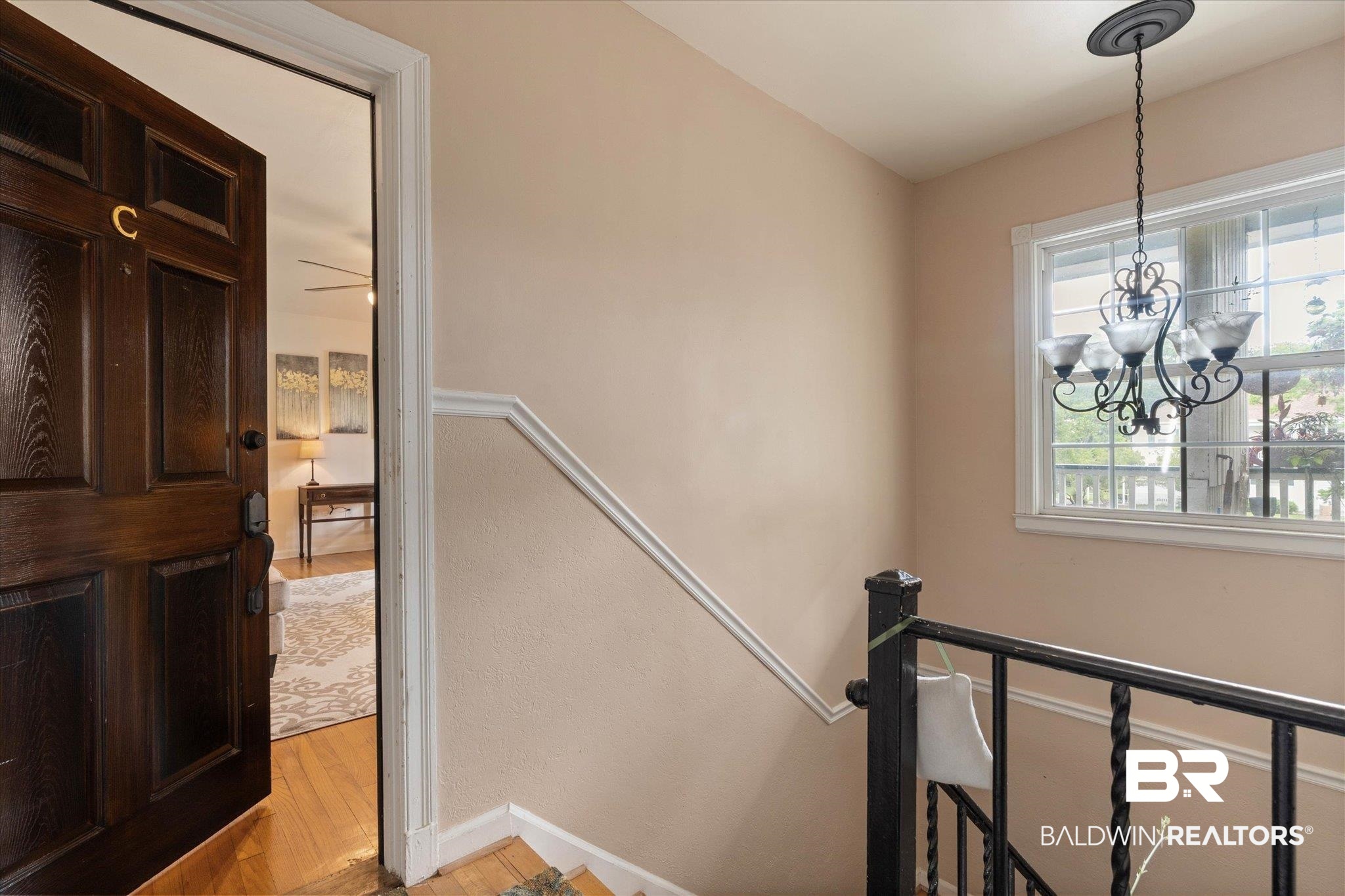 214 Upham Street, Unit 18C Mobile, AL 36607 - Photo 18 of 35 Stairs with wood finished floors, a chandelier, and baseboards