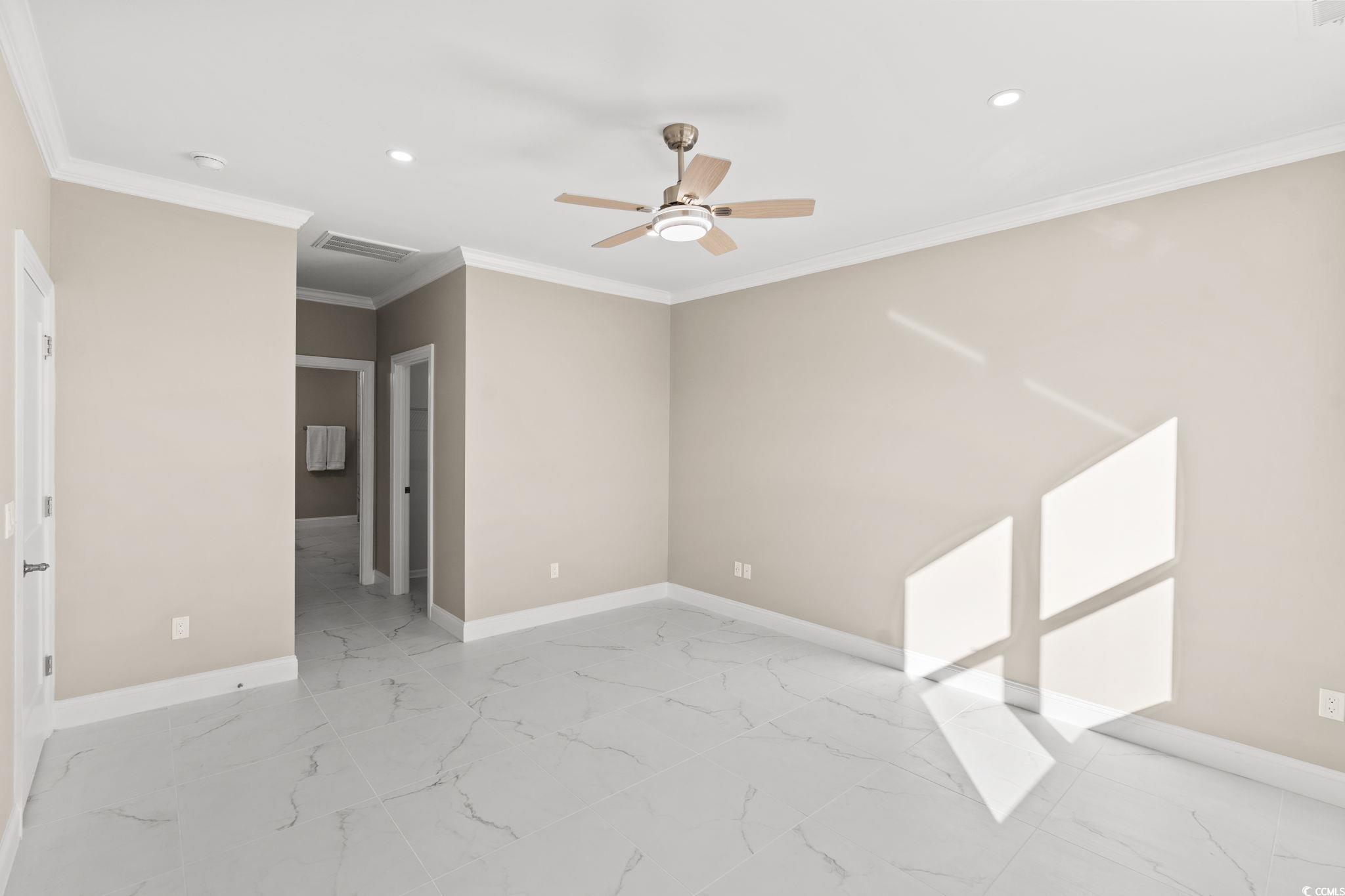 600 Table Rock Court Myrtle Beach, SC 29579 - Photo 16 of 37 Spare room with ceiling fan, crown molding, light marble finish floors, and recessed lighting