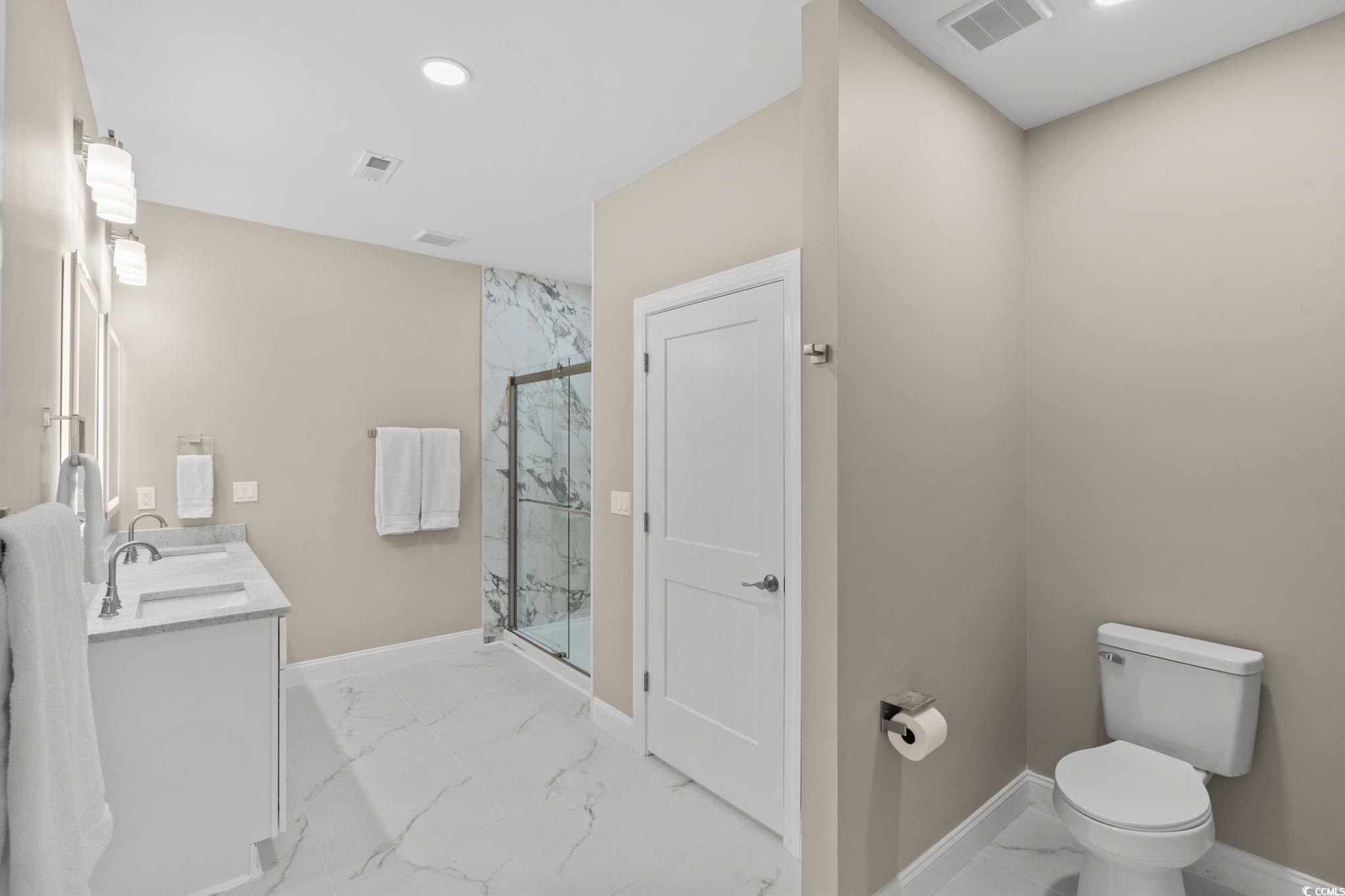 600 Table Rock Court Myrtle Beach, SC 29579 - Photo 18 of 37 Full bathroom with light marble finish flooring, double vanity, a marble finish shower, and recessed lighting