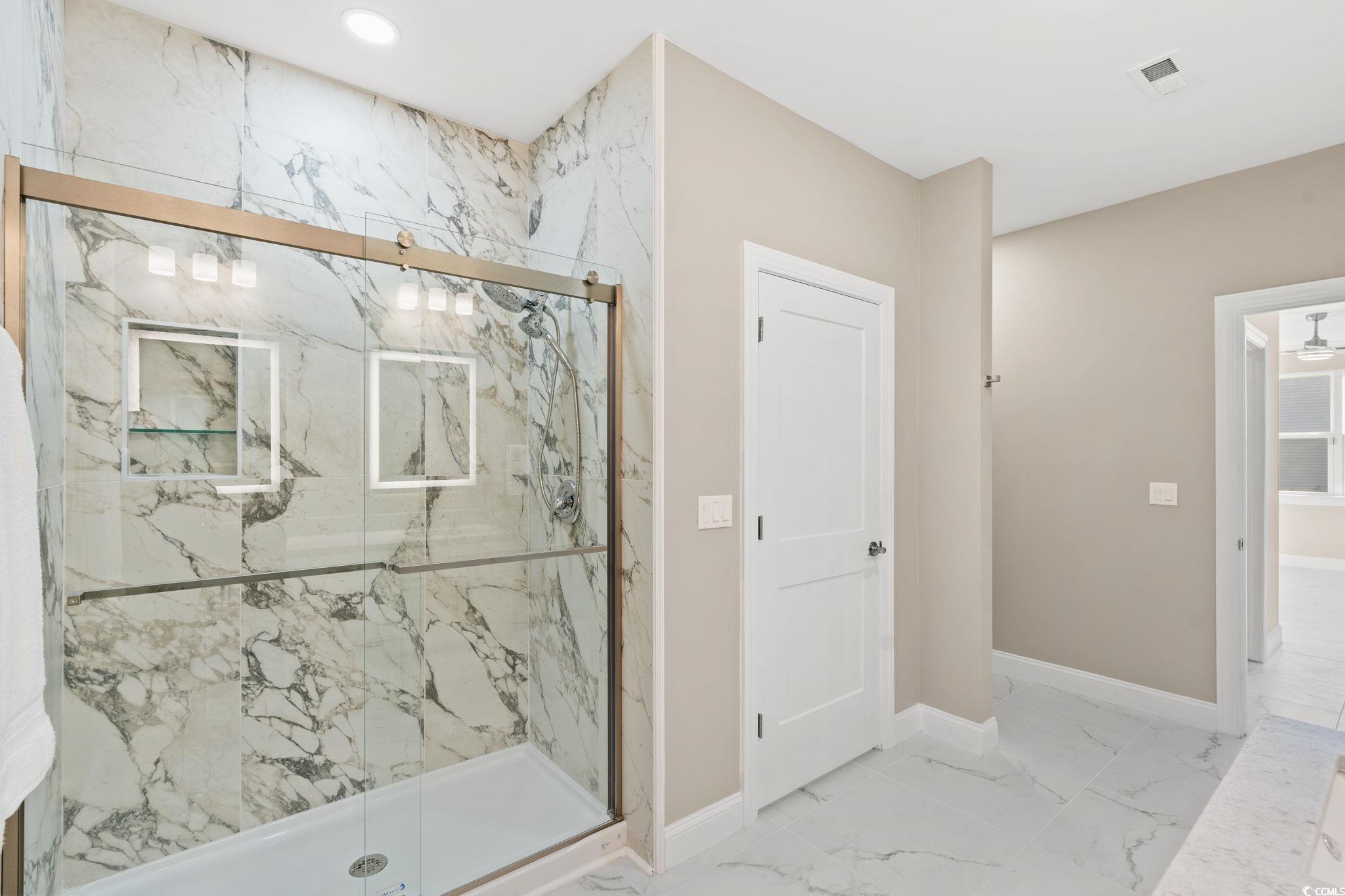 600 Table Rock Court Myrtle Beach, SC 29579 - Photo 20 of 37 Bathroom featuring marble look tiles and a marble finish shower
