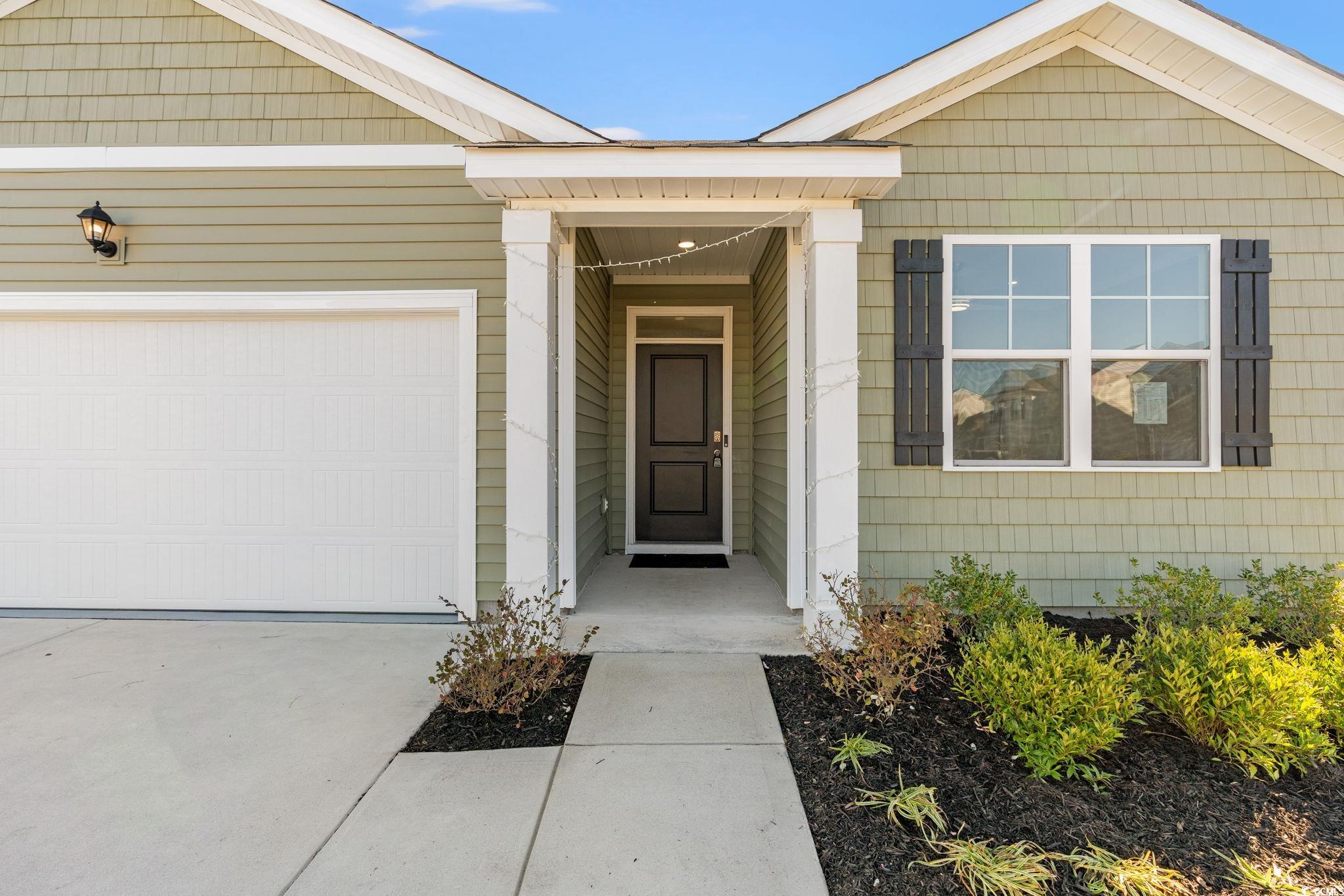 600 Table Rock Court Myrtle Beach, SC 29579 - Photo 2 of 37 View of exterior entry with an attached garage and driveway