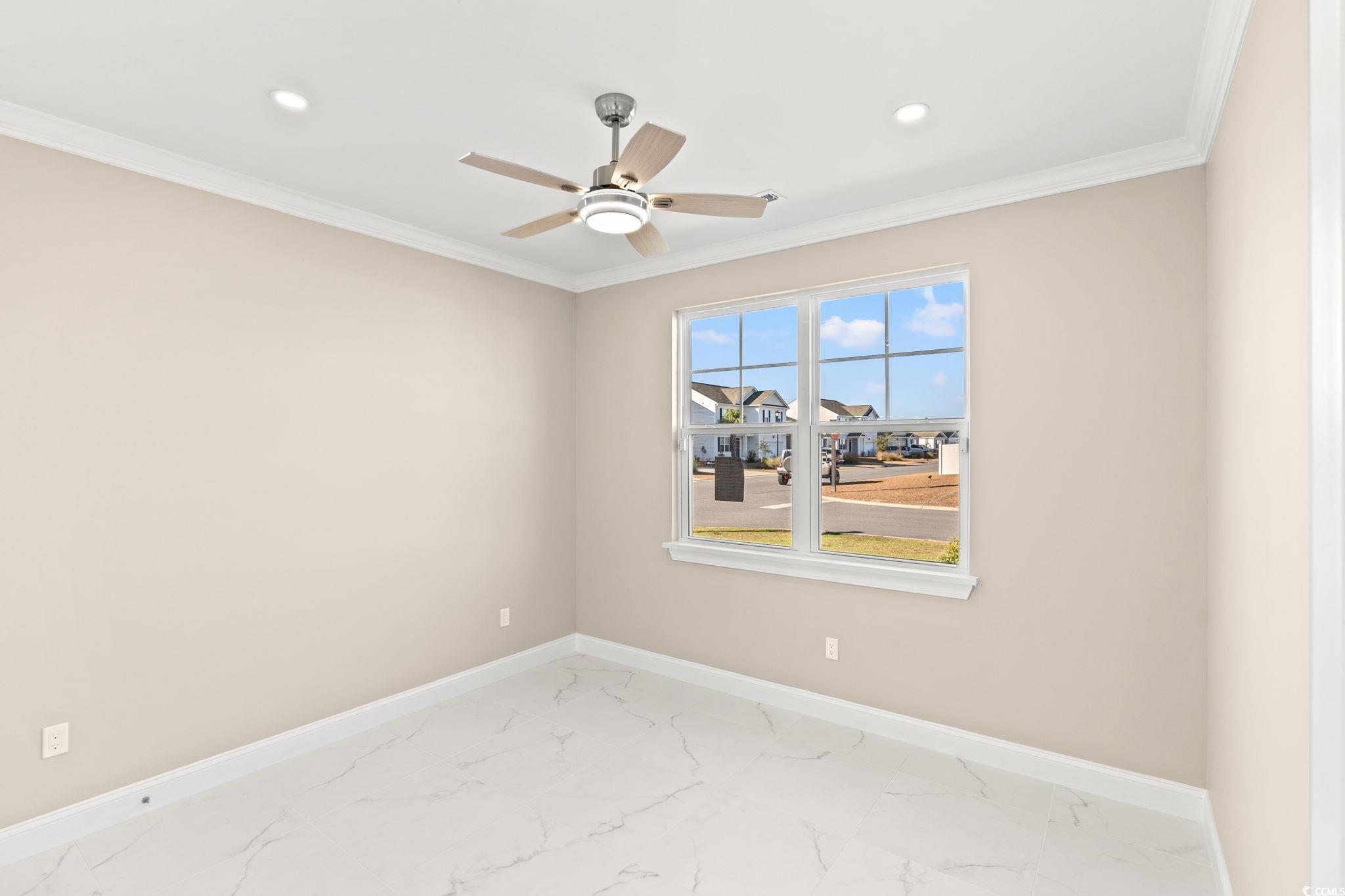 600 Table Rock Court Myrtle Beach, SC 29579 - Photo 22 of 37 Unfurnished room featuring crown molding, a ceiling fan, marble look tile flooring, and recessed lighting