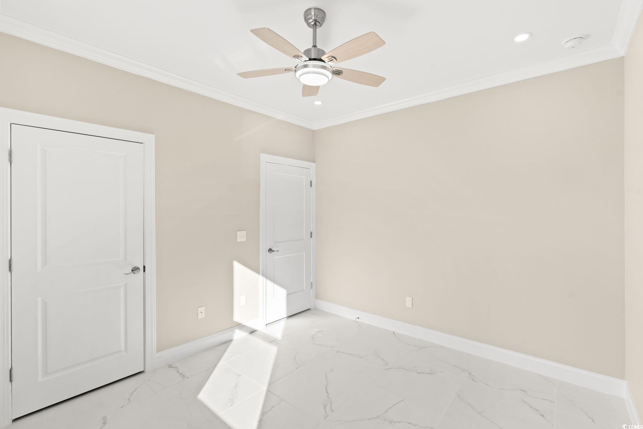 600 Table Rock Court Myrtle Beach, SC 29579 - Photo 26 of 37 Unfurnished bedroom featuring light marble finish flooring, ornamental molding, a ceiling fan, and recessed lighting
