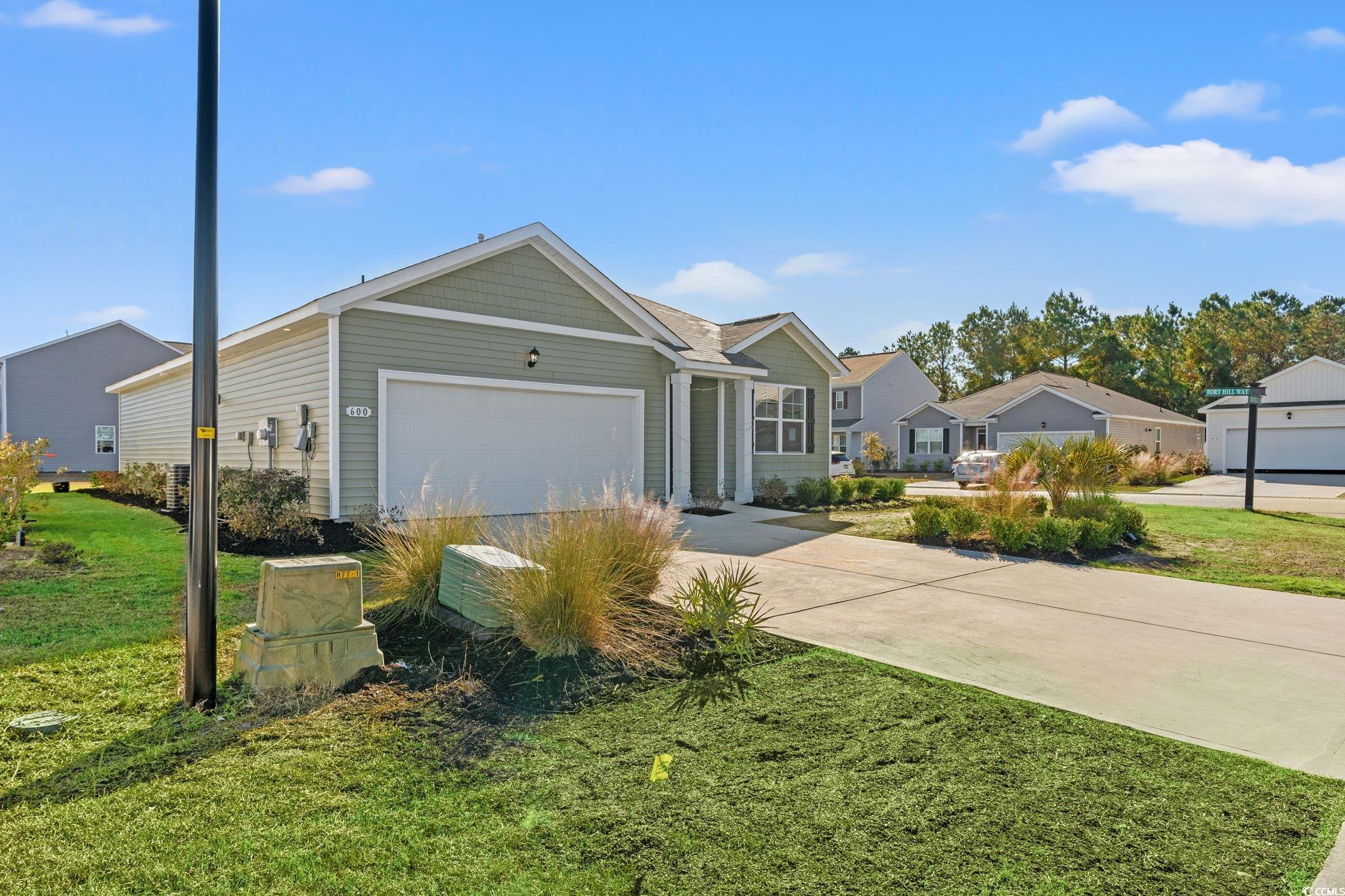 600 Table Rock Court Myrtle Beach, SC 29579 - Photo 33 of 37 View of front of home featuring a front lawn, concrete driveway, and a garage