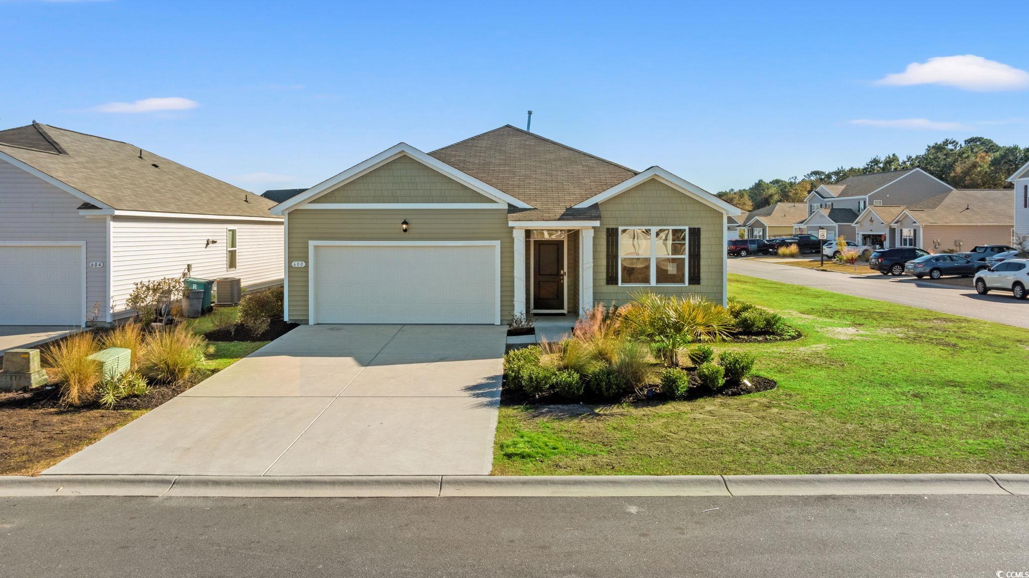 600 Table Rock Court Myrtle Beach, SC 29579 - Photo 35 of 37 View of front facade with a front yard, concrete driveway, an attached garage, and a residential view