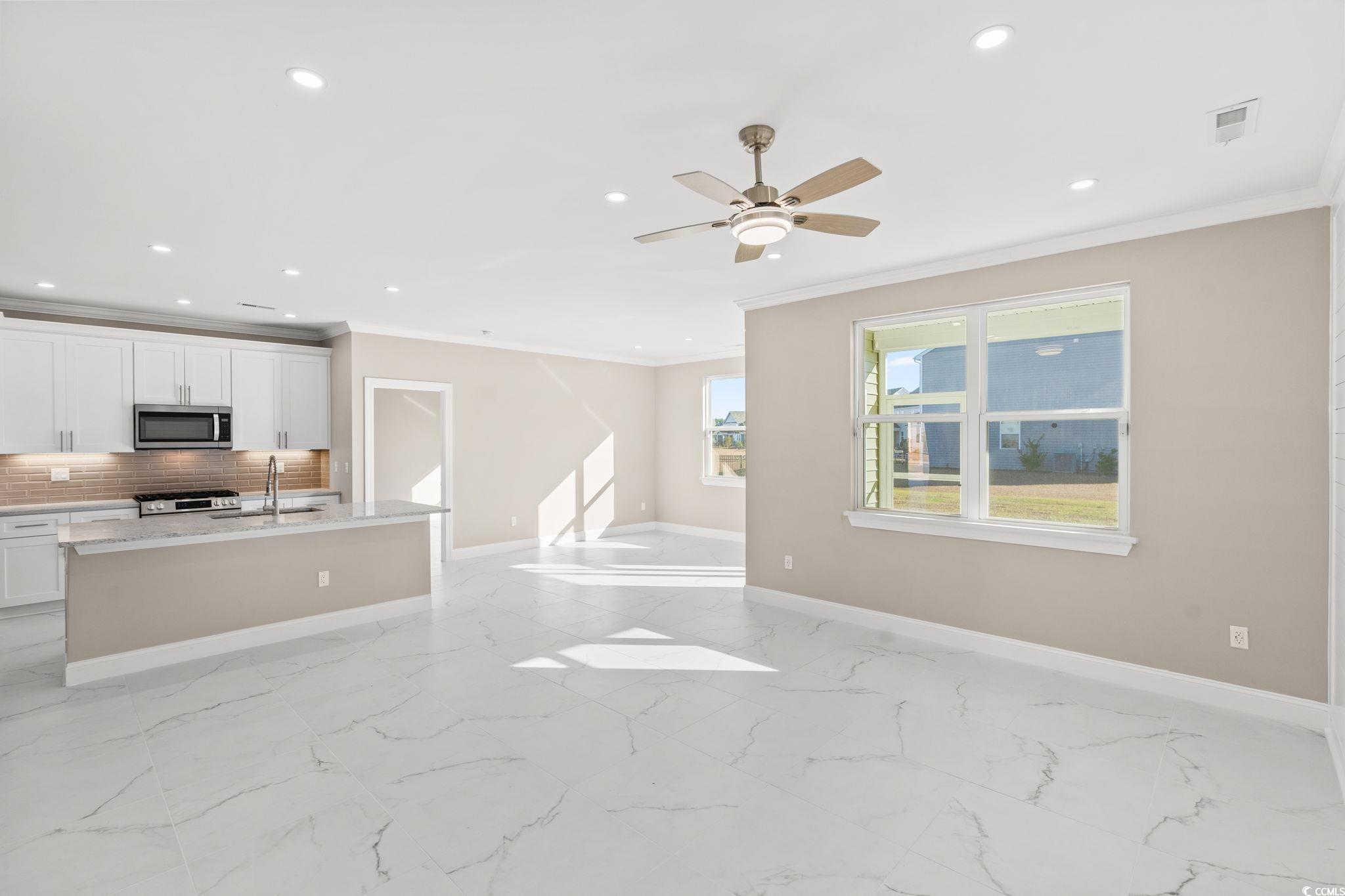 600 Table Rock Court Myrtle Beach, SC 29579 - Photo 6 of 37 Unfurnished living room featuring recessed lighting, crown molding, ceiling fan, and light marble finish flooring