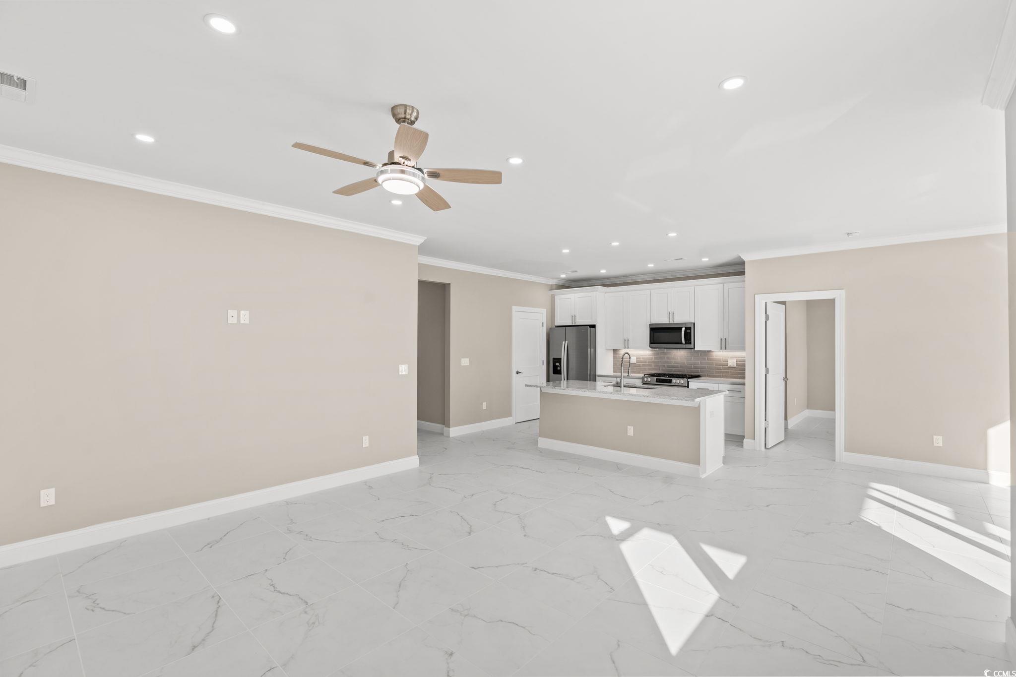 600 Table Rock Court Myrtle Beach, SC 29579 - Photo 7 of 37 Unfurnished living room featuring recessed lighting, ornamental molding, light marble finish floors, and a ceiling fan