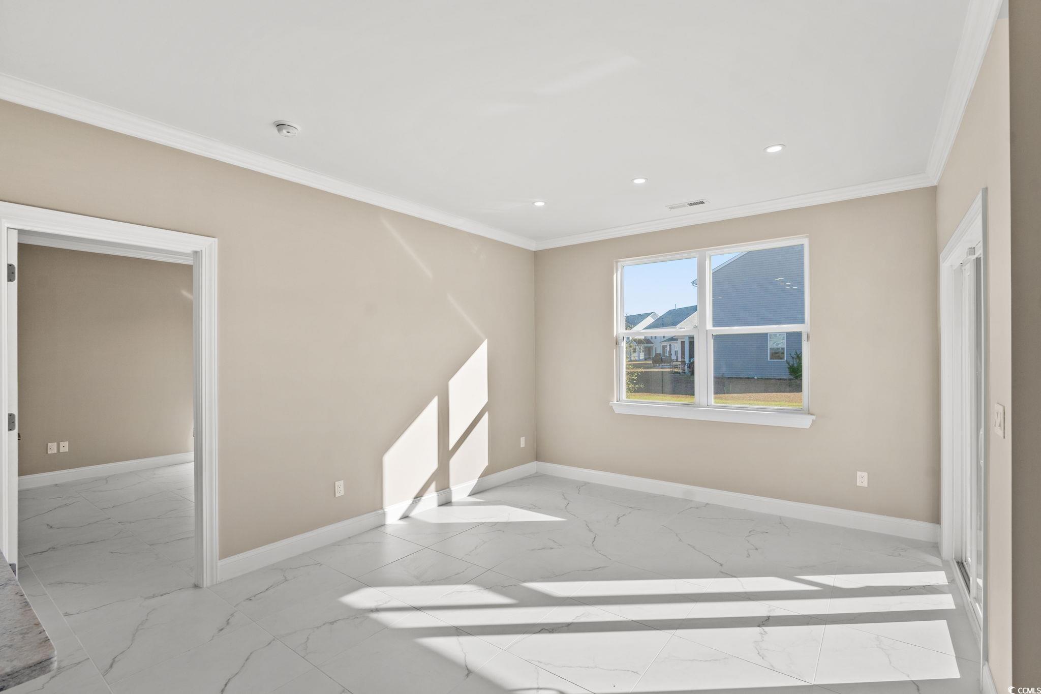 600 Table Rock Court Myrtle Beach, SC 29579 - Photo 9 of 37 Empty room featuring light marble finish flooring, ornamental molding, and recessed lighting