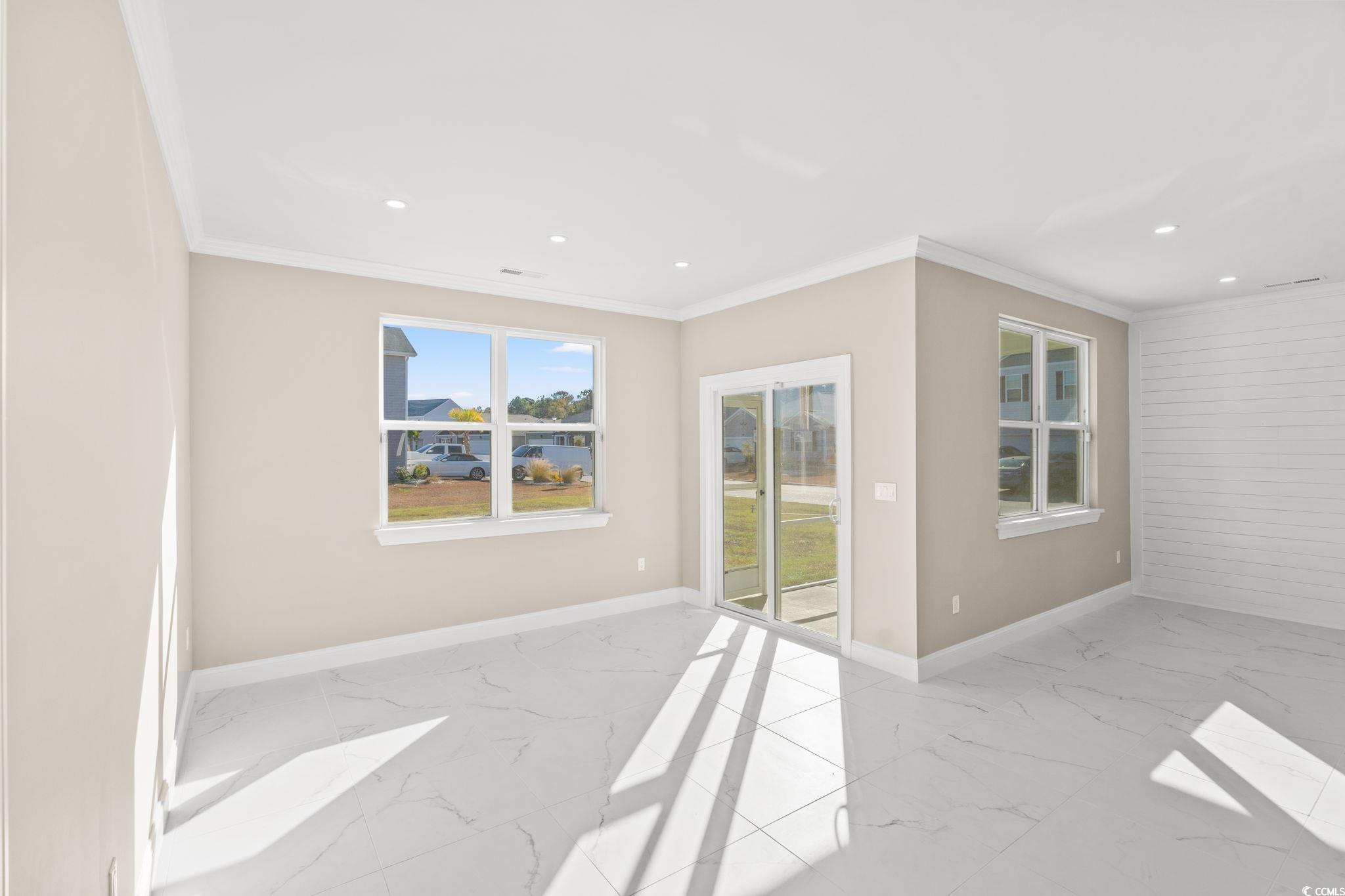 600 Table Rock Court Myrtle Beach, SC 29579 - Photo 10 of 37 Unfurnished room featuring light marble finish flooring, crown molding, and recessed lighting