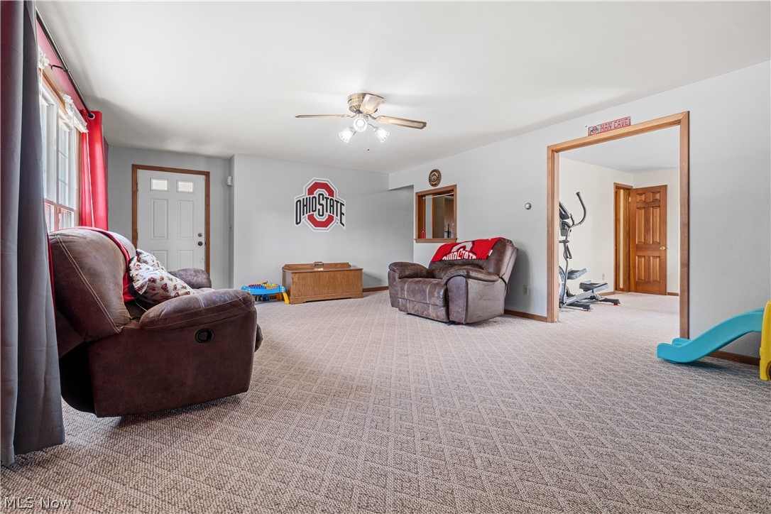 3650 Rambo Avenue Alliance, OH 44601 - Photo 23 of 36 Neutral wall finishes, patterned carpeting, natural wood-finish trim, and a ceiling fan with integrated lighting