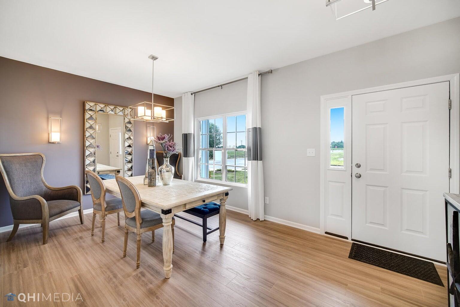 2845 East 105th Avenue Crown Point, IN 46307 - Photo 11 of 24 a view of a dining room with furniture and wooden floor