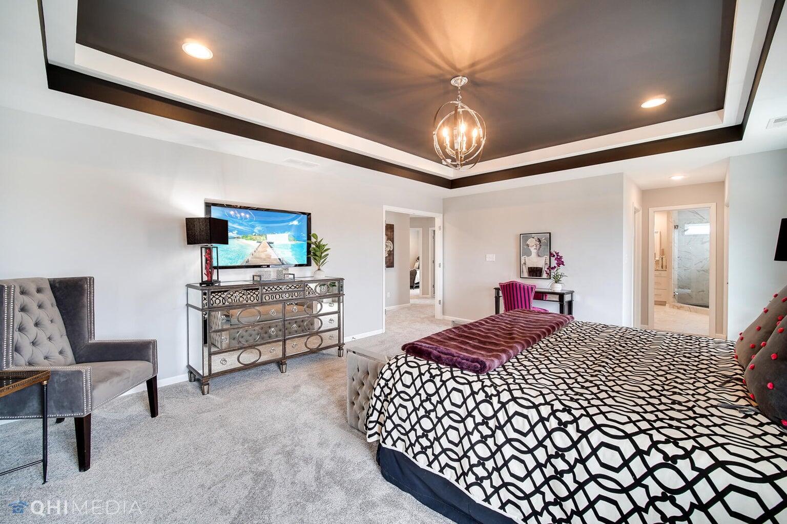 2845 East 105th Avenue Crown Point, IN 46307 - Photo 18 of 24 a bedroom with furniture and a flat screen tv