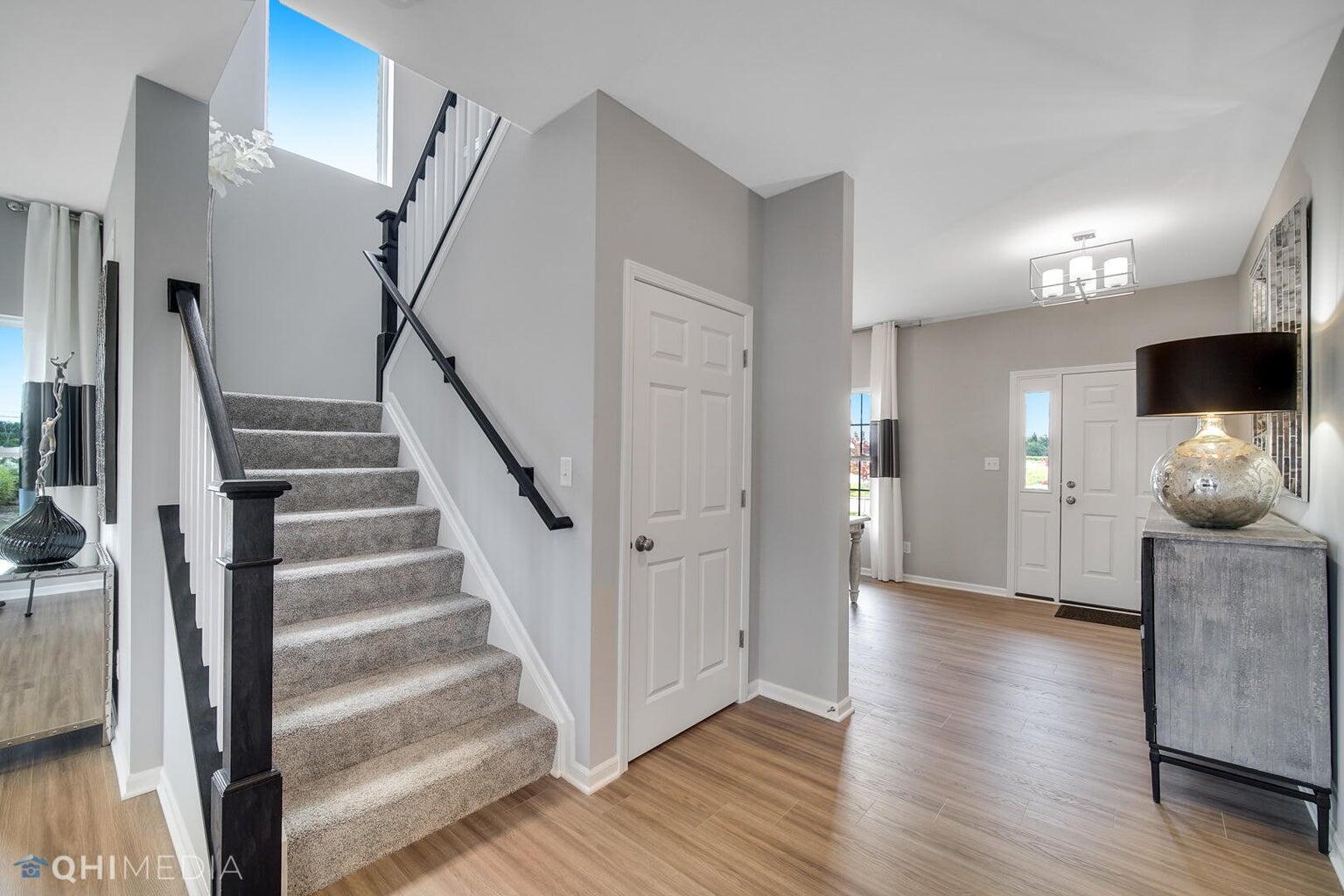 2845 East 105th Avenue Crown Point, IN 46307 - Photo 2 of 24 a view of a hallway with wooden floor and staircase