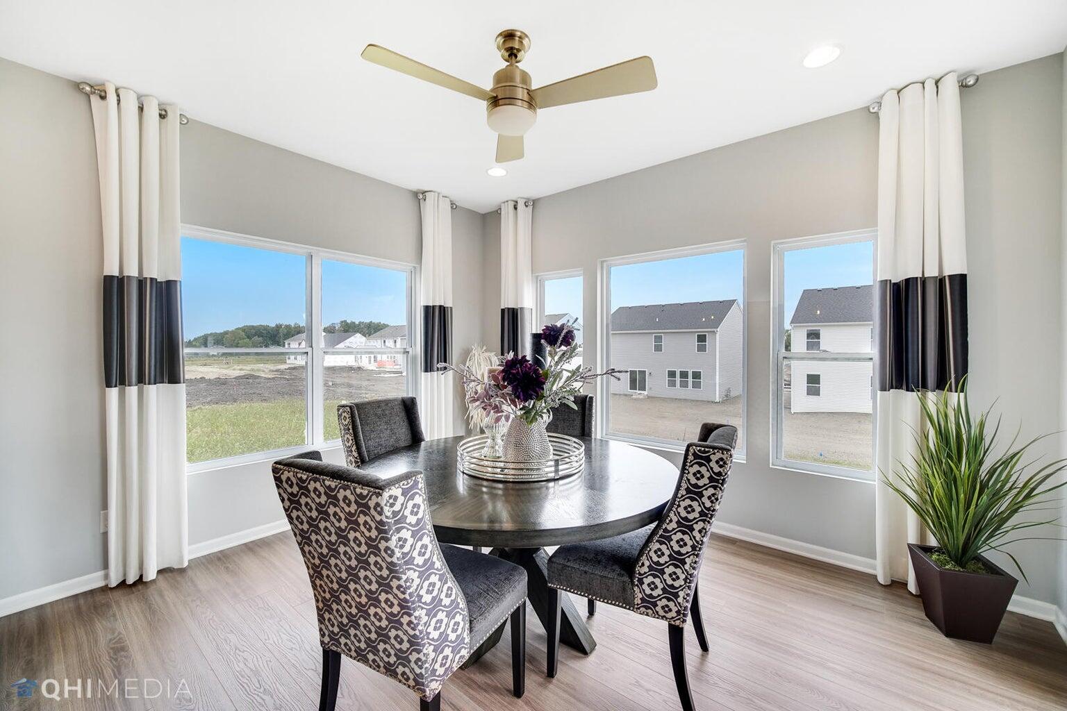 2845 East 105th Avenue Crown Point, IN 46307 - Photo 10 of 24 a view of a dining room with furniture window and wooden floor