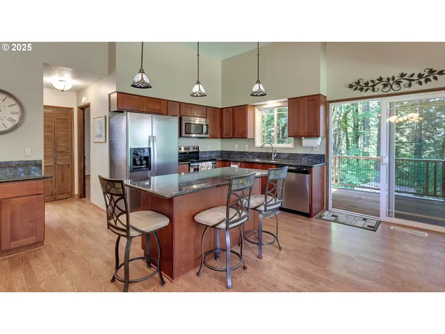 a kitchen with a table chairs refrigerator and sink