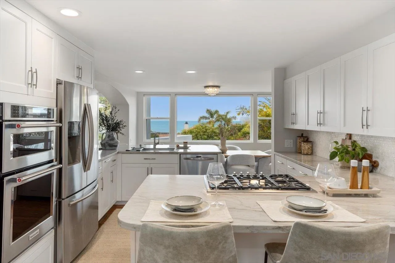 13726 Pine Needles Drive Del Mar, CA 92014 - Photo 21 of 70 a kitchen with stainless steel appliances kitchen island granite countertop a sink and cabinets