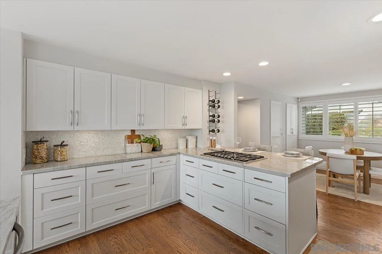 13726 Pine Needles Drive Del Mar, CA 92014 - Photo 22 of 70 a kitchen with granite countertop white cabinets and white appliances