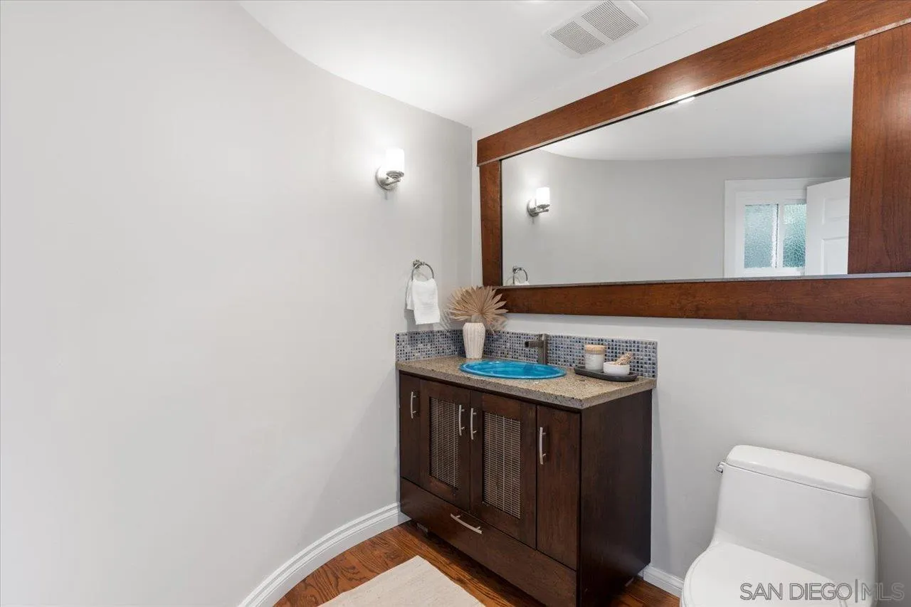 13726 Pine Needles Drive Del Mar, CA 92014 - Photo 24 of 70 a bathroom with a toilet a sink and mirror