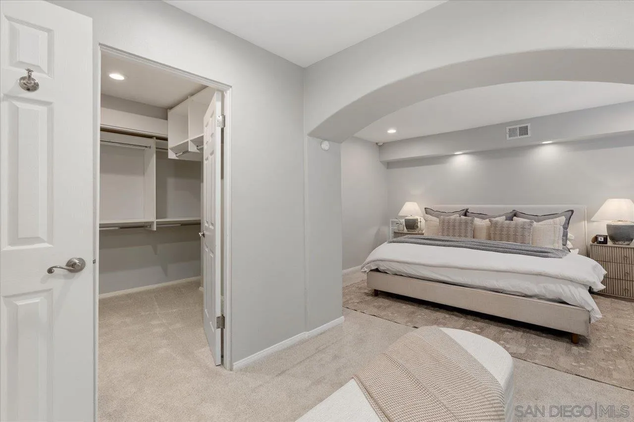 13726 Pine Needles Drive Del Mar, CA 92014 - Photo 32 of 70 a spacious bedroom with a bed and a walk in closet
