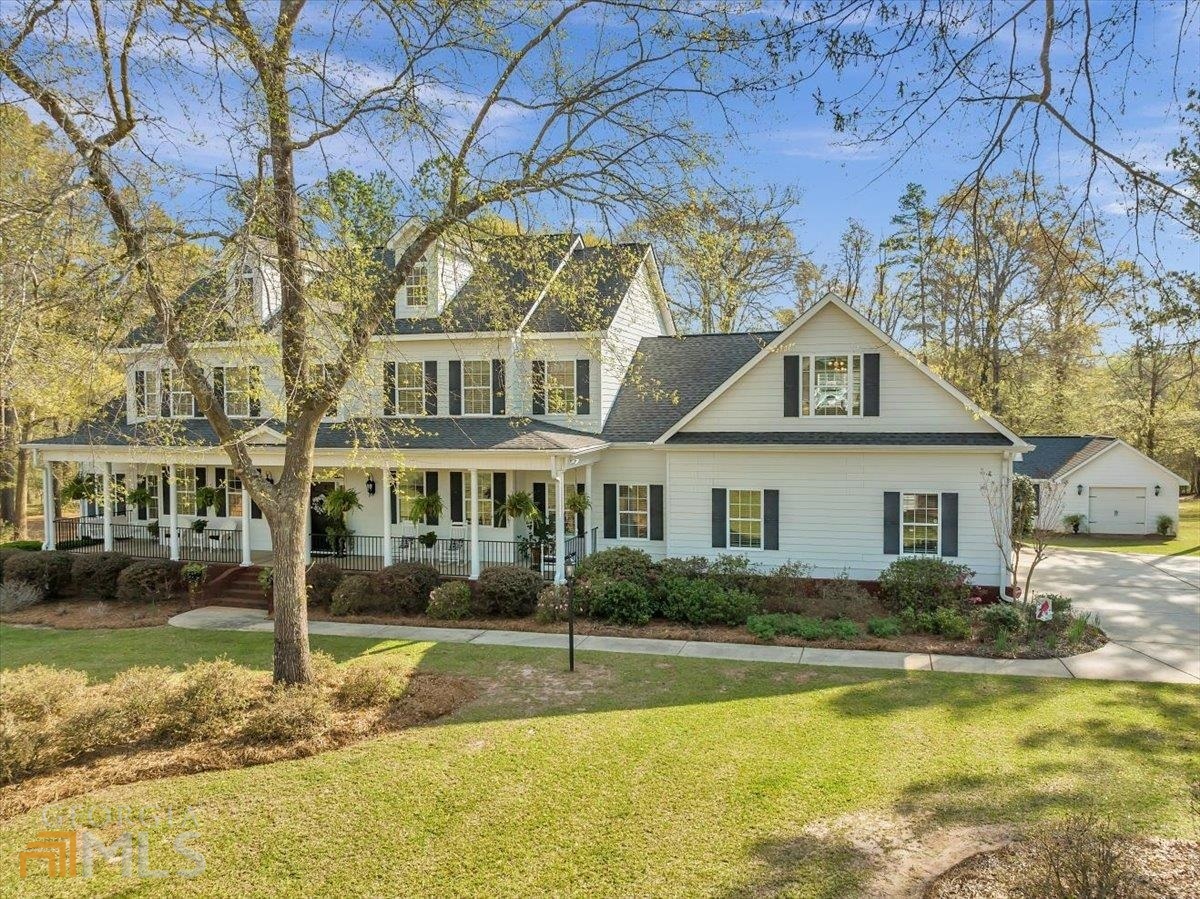 a front view of a house with swimming pool and glass windows