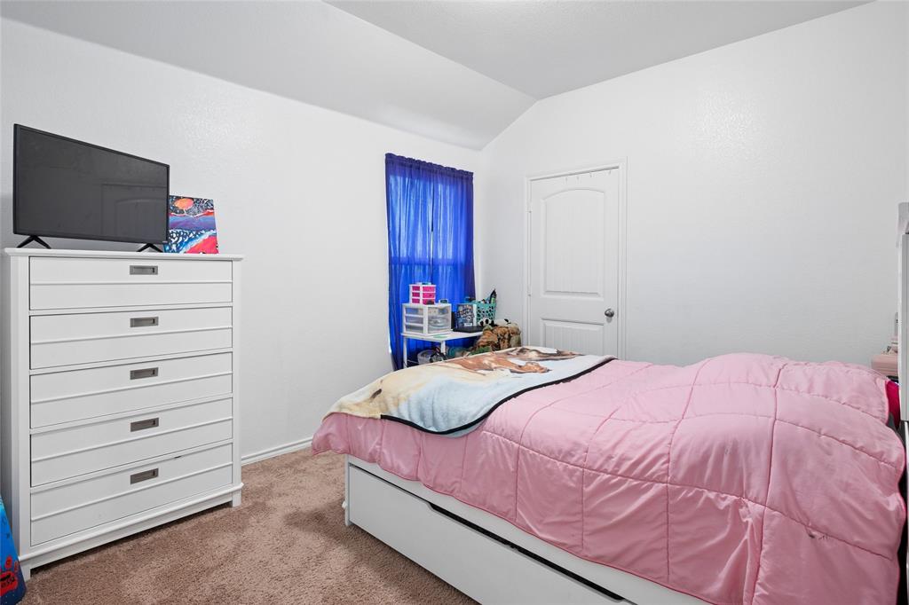 324 Fairgrounds Lane Ponder, TX 76259 - Photo 16 of 40 a bedroom with a bed and a flat screen tv