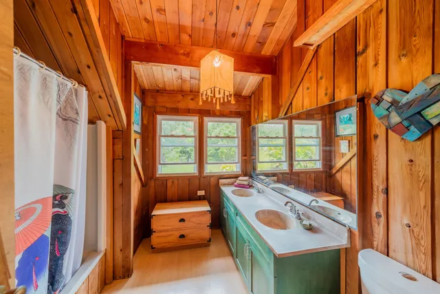 a front view of a house with yard and green space