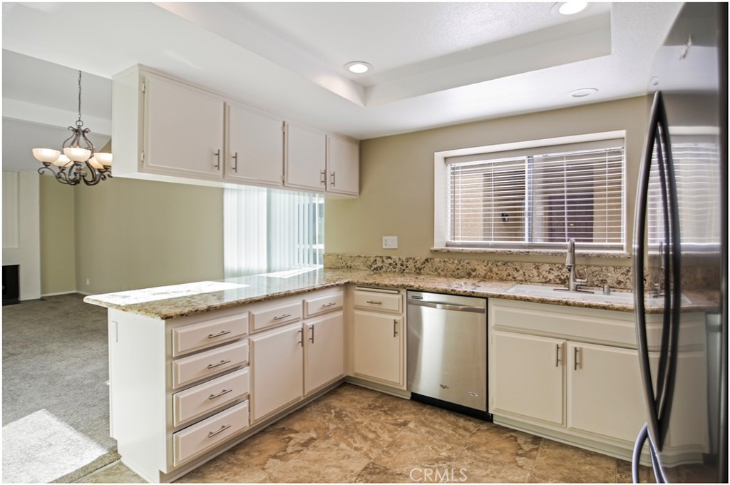 24802 Leto Circle Mission Viejo, CA 92691 - Photo 13 of 27 a kitchen with granite countertop a sink and cabinets