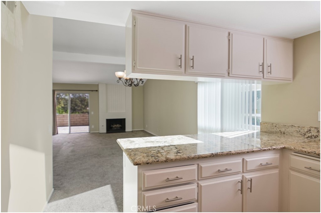 24802 Leto Circle Mission Viejo, CA 92691 - Photo 14 of 27 a bathroom with a granite countertop sink and a mirror
