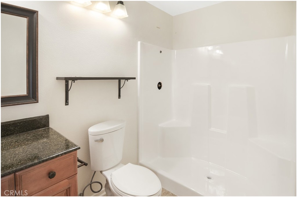 24802 Leto Circle Mission Viejo, CA 92691 - Photo 17 of 27 a bathroom with a granite countertop sink toilet and shower