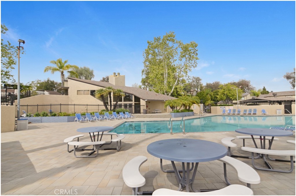 24802 Leto Circle Mission Viejo, CA 92691 - Photo 24 of 27 a view of a patio with table and chairs with wooden floor and fence