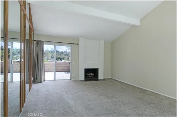 a view of an empty room with a fireplace