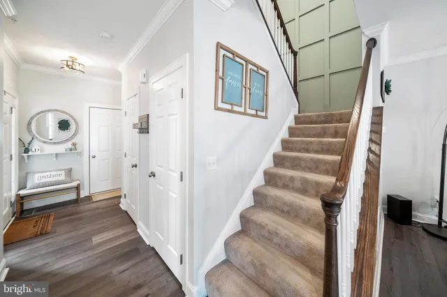 a view of a hallway with wooden floor and entryway