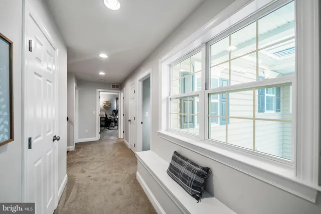 a view of a bathroom with tub and windows