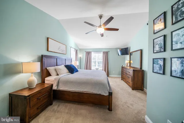 a bedroom with a bed couch and a window