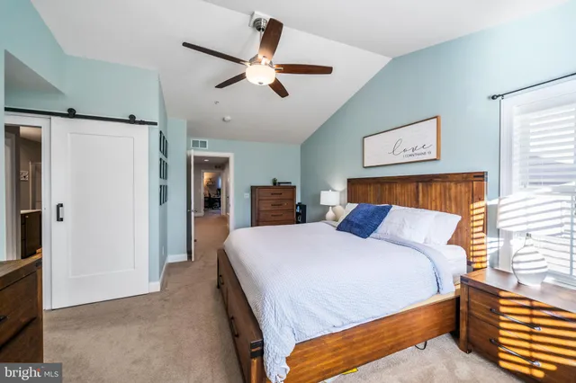 a bedroom with a large bed and a chandelier