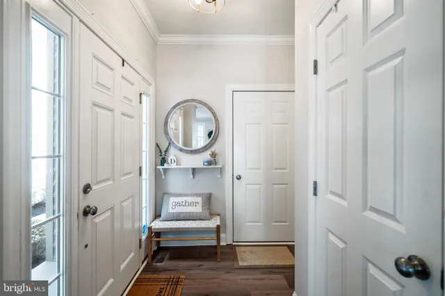 a view of a bathroom with wooden floor and white doors