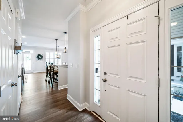a view of a hallway with wooden floor and closet area