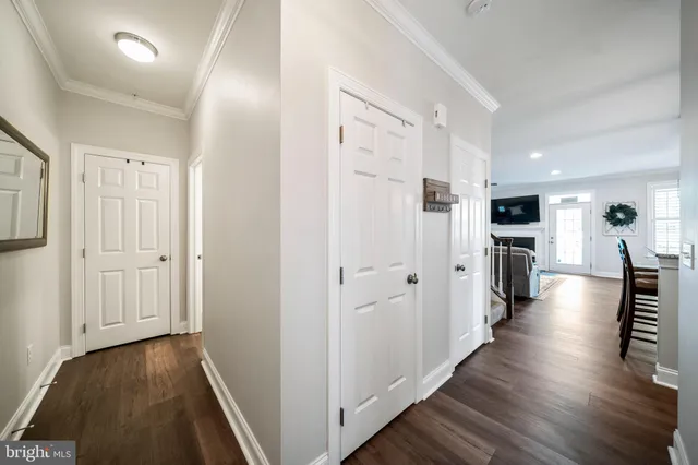 a view of a hallway with wooden floor and furniture