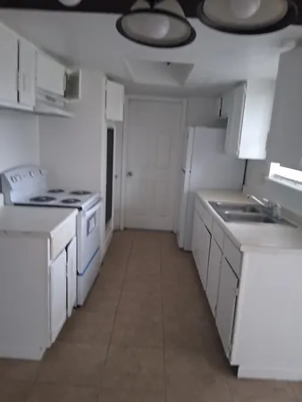 a kitchen with stainless steel appliances granite countertop a sink and cabinets