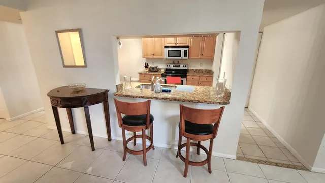 a dining room with furniture and a window