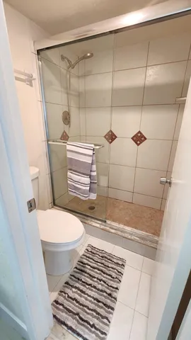 a bathroom with a toilet and a shower