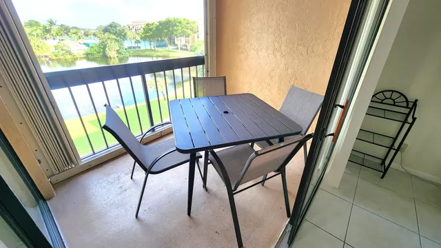 a view of balcony with furniture and window